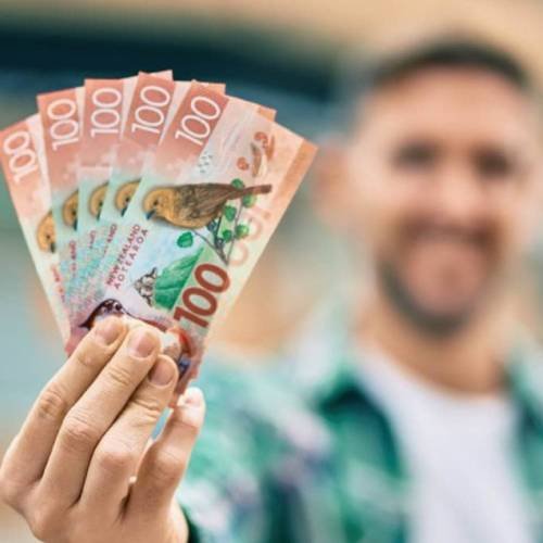 Man holding cash payment for selling his car in Rotorua