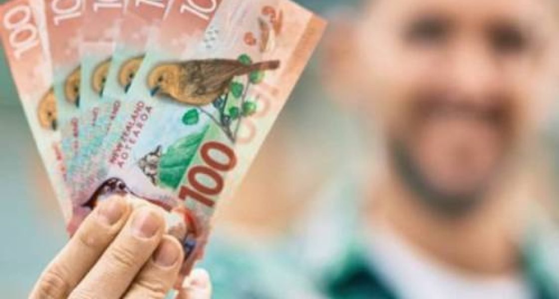 Man holding cash payment for selling his car in Rotorua